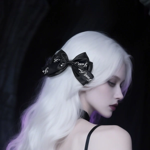 Detail of a black ribbon bow hairclip with 'Just for you' text on white gradient hair
