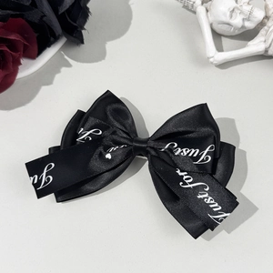 Gothic black satin ribbon hair clip with white lettering and elegant rose accents