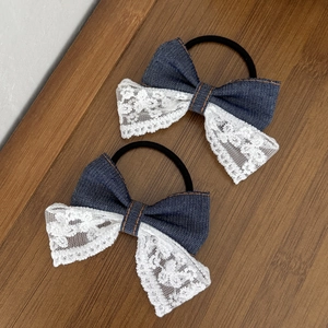 Detailopname van handgemaakte denim en kant haarstrikken op een houten ondergrond