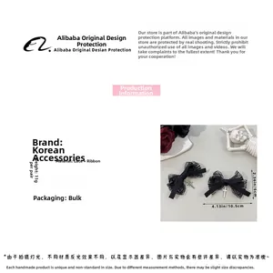 Detailed view of black lace bow hair clips with silver cross pendants and ribbon texture