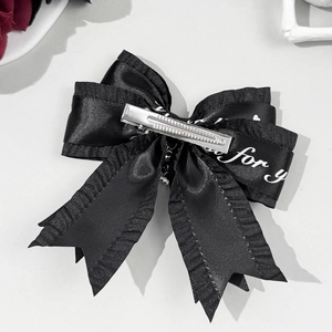 Lolita style black satin bow hair clip with ruffle edges and metallic duckbill clip