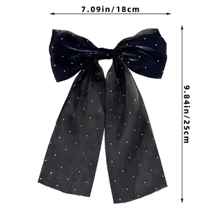 Detailed size view of a large black organza bow hair clip with sparkling silver sequins