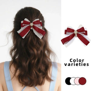 Detail of red lolita lace bow hair clip with pearl pendant and color options