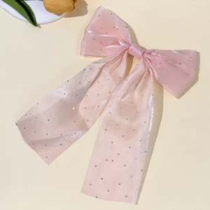 Detailed view of pink shimmer organza bow hair clip with sparkling silver rhinestones