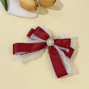Detail of Lolita wine red satin bow hair clip with white lace and pearl pendant