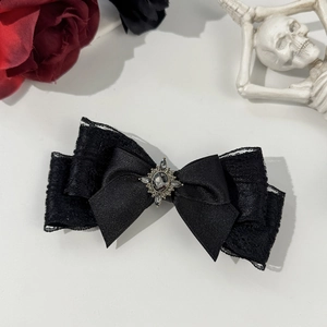 Detail of Gothic black lace ribbon hair clip with vintage grey stone and dark floral decor