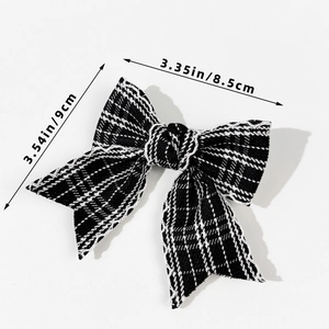 Detailed size view of black and white plaid bow hair clip measuring 8.5cm by 9cm