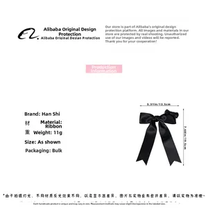 Detail view of a black ribbon bow hair clip showing dimensions of 13.5cm width and 19.5cm height