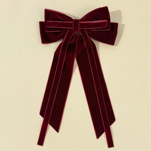 Elegant wine red velvet bow hair clip with long ribbons in a vintage aesthetic