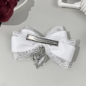 Dark Lolita white lace bow hair clip with silver heart cross pendant on grey surface