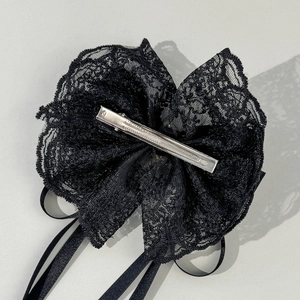 Elegant black lace bow hair clip with long satin ribbons and silver duckbill clip