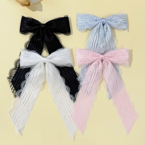 Elegant lace bow hair clips in black, white, blue and pink with scalloped edge detail