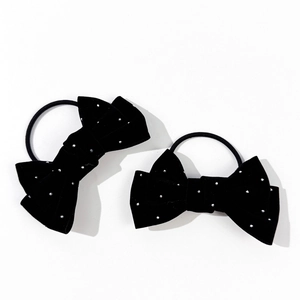 Detail of black velvet bow hair ties with silver studs and elastic bands for women