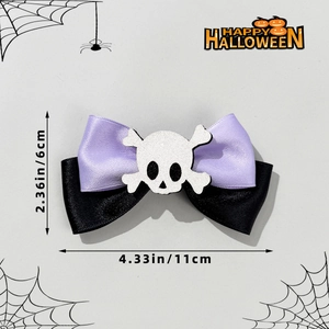 Purple and black satin Halloween bow hair clip featuring a white skull and crossbones