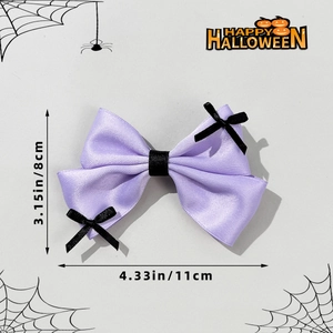 Detail view of purple satin Halloween bow with skull accent and size measurements