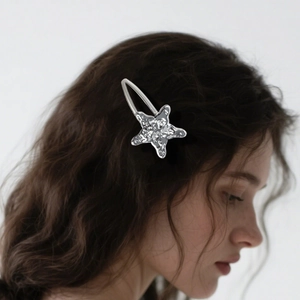 Y2K style silver star hair clip with hammered metal texture worn by a model