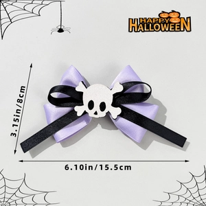 Detail view of a 15.5cm Halloween bow hair clip with skull center and purple ribbon