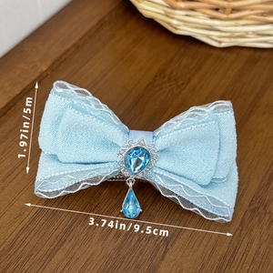 Detail of blue bow hair clip with lace trim, gemstone pendant and size measurements