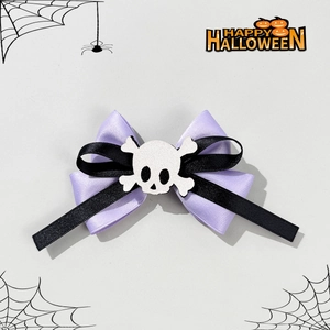 Gothic Halloween hair clip featuring purple satin bow and white skull charm on grey background