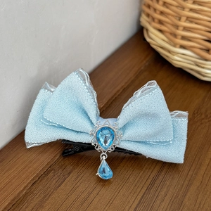 Princess light blue bow hair clip with teardrop blue gemstone and silver metal trim