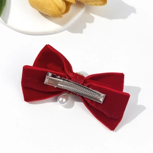 French vintage red velvet bow hair clip with pearl pendant on a white background
