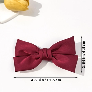 Deep red satin bow hair clip with size dimensions shown on a clean white background