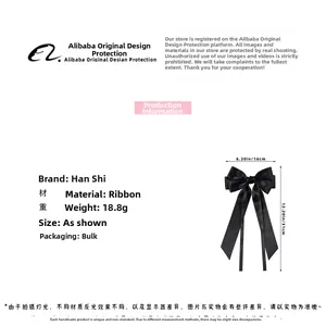 Detailed view of large black ribbon bow hair clip with 16cm width and silky texture