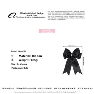 Close-up of elegant black satin bow hair clip showing silk-like texture and 16cm width