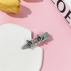 Silver Y2K metal hair clip with hollow stars and dark gray rhinestones on stone base