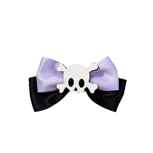 Halloween purple and black bow hair clip with glittery skull and crossbones ornament
