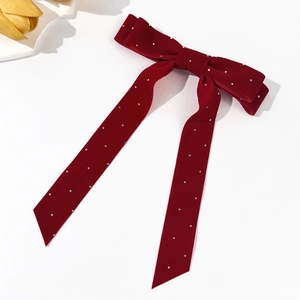 Elegant red velvet bow hair clip with sparkling rhinestones and long flowing ribbons