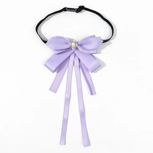 Detail showing purple satin bowknot with a pearl rhinestone center and adjustable strap