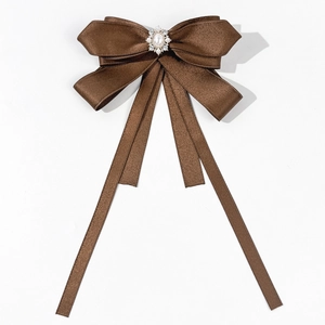 Detail of coffee brown satin bow tie with vintage pearl and rhinestone crystal centerpiece