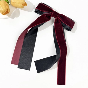 Détail de la grande pince à cheveux à double nœud en velours et satin avec rubans