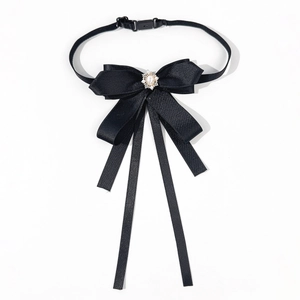 Close-up of black satin bow tie with teardrop faux pearl and rhinestone centerpiece