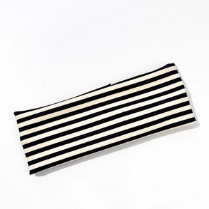 Detailed close-up of striped elastic yoga headband with premium knitted cotton texture
