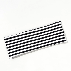 Close-up of black and white striped elastic headband with premium ribbed texture