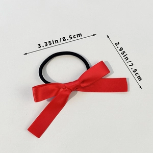 Elastic black hair tie featuring a red satin ballet-style bow with 3.35 inch width
