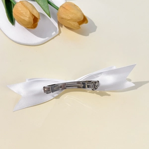 Elegant white satin ribbon bow hair clip with silver metal spring fastener for women