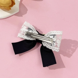 Elegant velvet bow hair clip with lace trim and metal duckbill clip on pink background