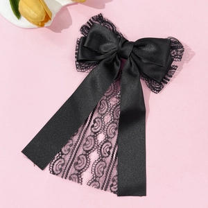 Detail of elegant black lace and satin layered bow hairclip with long flowing streamers