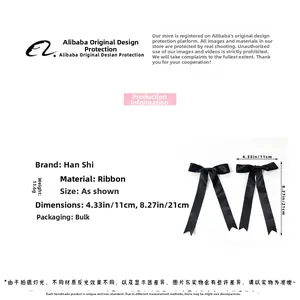 Detailed close-up showing the soft silk ribbon texture of the black ballet bow hair clips