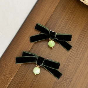 Pair of vintage dark green velvet bow hair clips with pale green cat-eye beads
