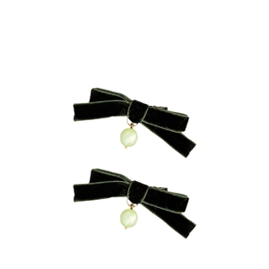 Pair of dark green velvet bow hair clips with pale green round beads on white background