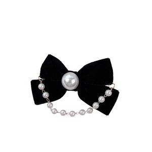 Vintage French velvet bow hair clip with pearl chain tassel on a clean white background