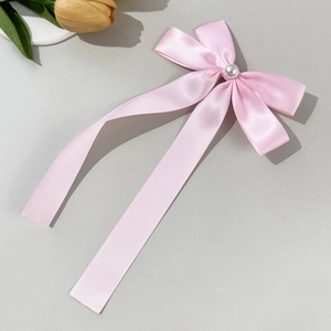 Pink satin bow hair clip with faux pearl center and elegant silky ribbon texture
