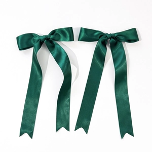 Pair of dark green satin bow hair clips with long ribbons and elegant fishtail ends