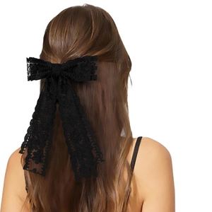 Close-up of black lace double-layered bow hair clip with elegant floral ribbon detail