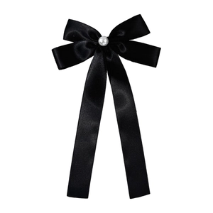 Elegant black satin bow hair clip with white pearl detail and long ribbon tails