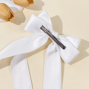 Elegant white satin bow hair clip with long ribbons and silver metal duckbill clip